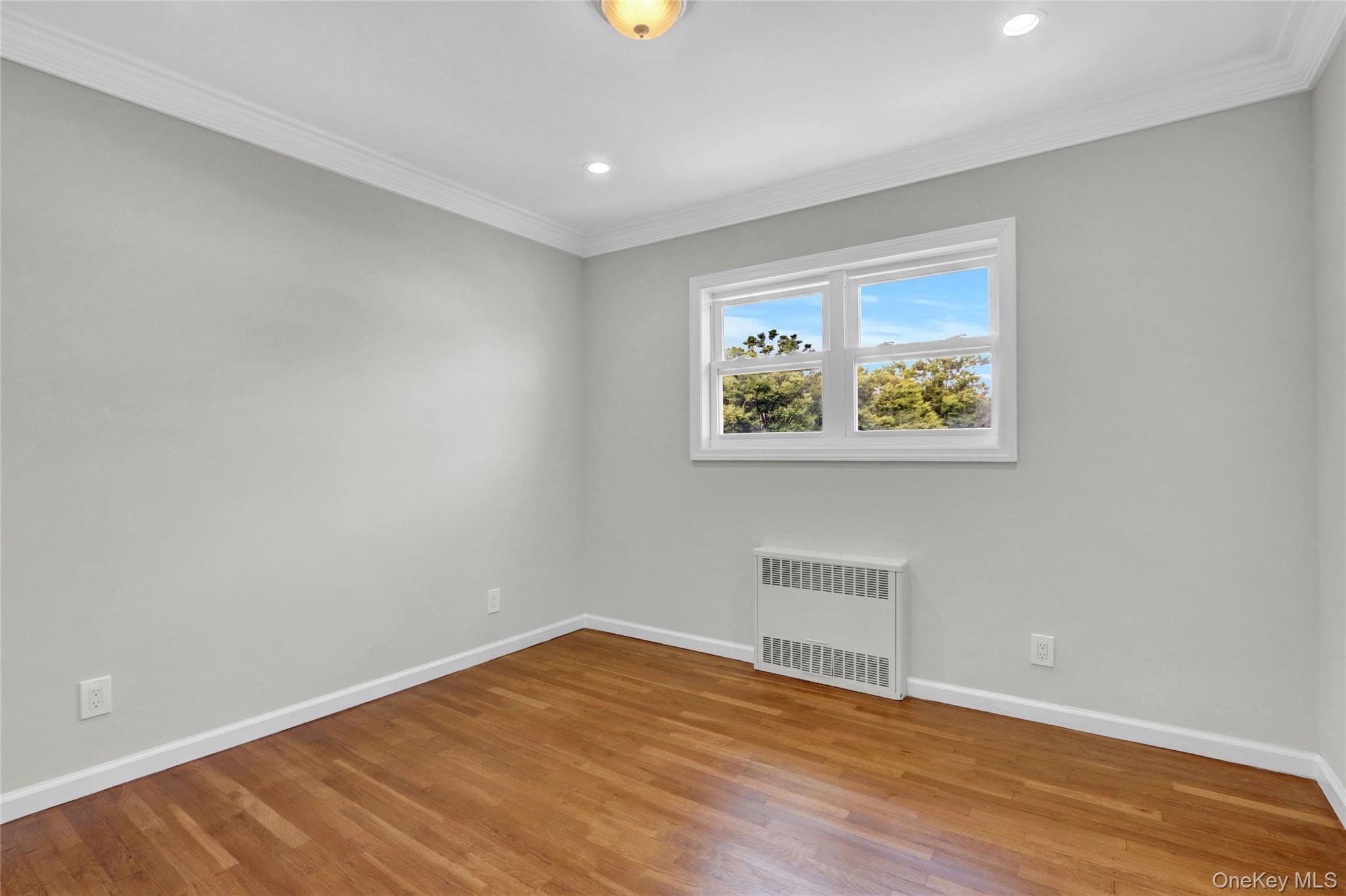 3621 Regent Lane Wantagh, NY 11793 - Photo 11 of 24 a view of an empty room with wooden floor and a window