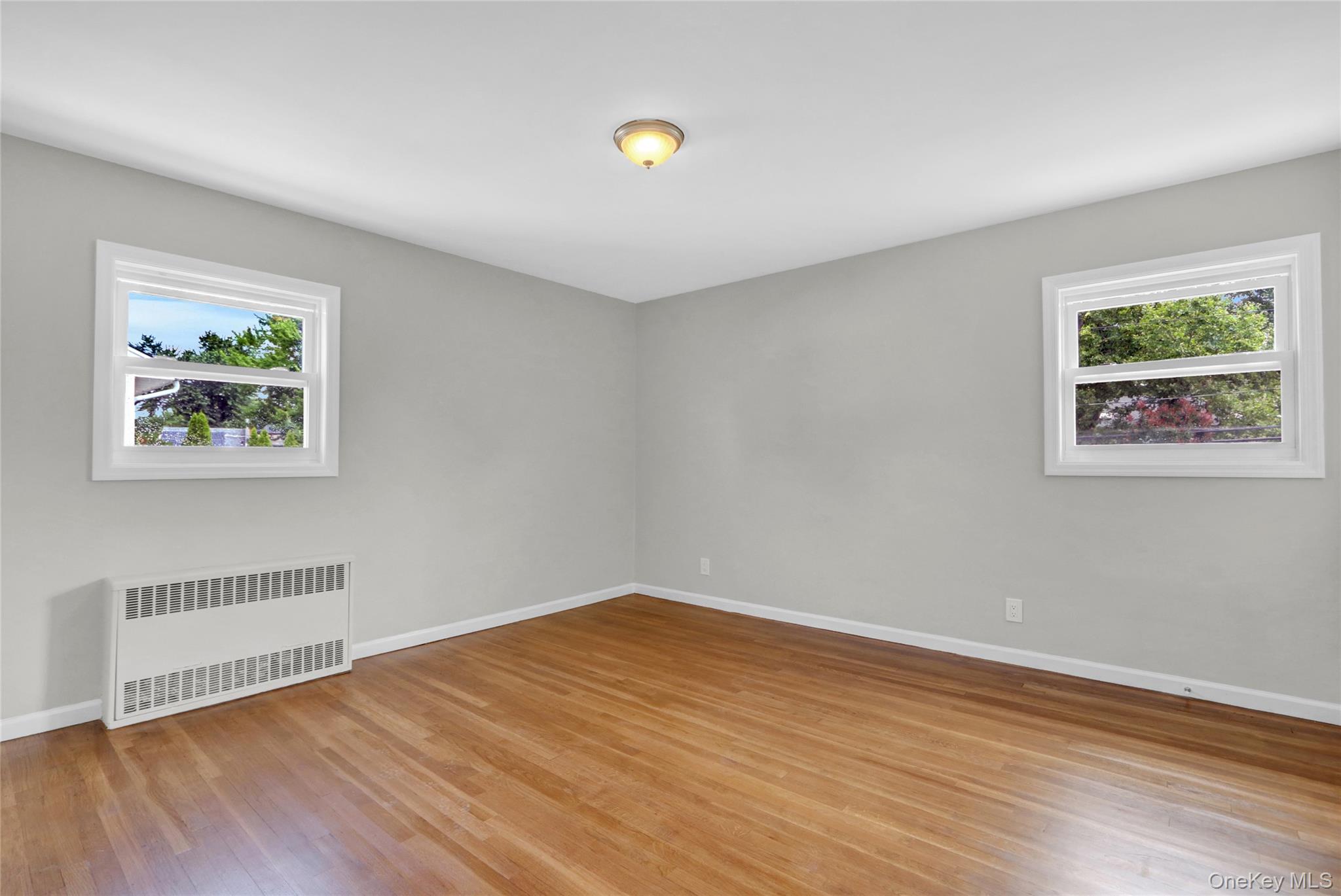 3621 Regent Lane Wantagh, NY 11793 - Photo 13 of 24 a view of empty room with wooden floor and window