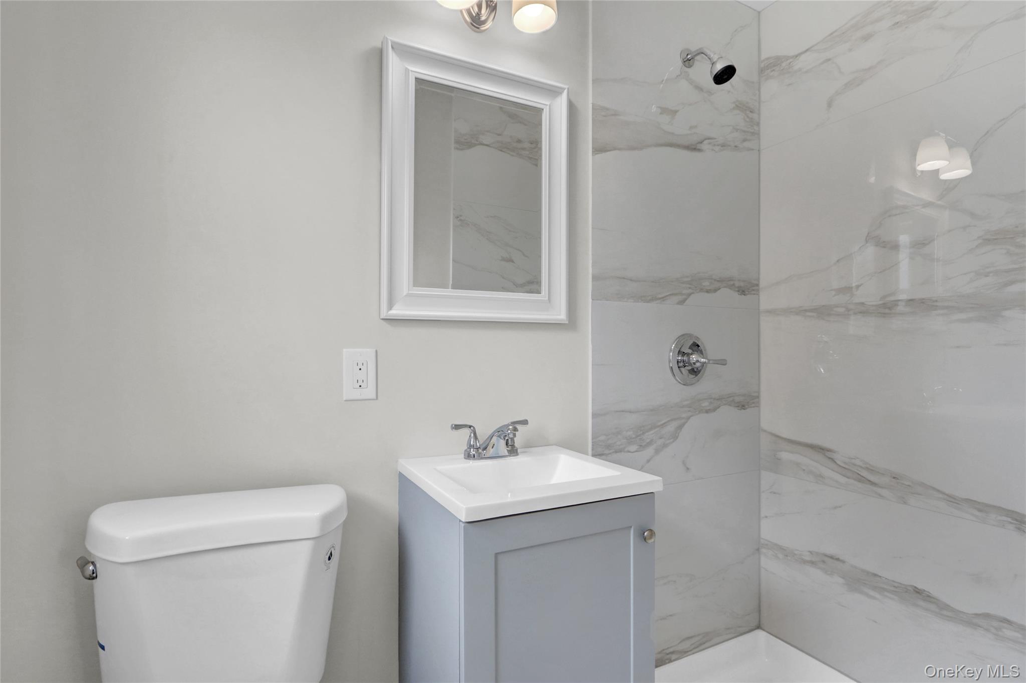3621 Regent Lane Wantagh, NY 11793 - Photo 14 of 24 a bathroom with a sink a toilet and shower