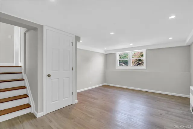 a view of a room with wooden floor and window