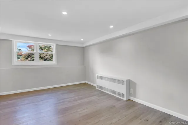 a view of room with wooden floor and window