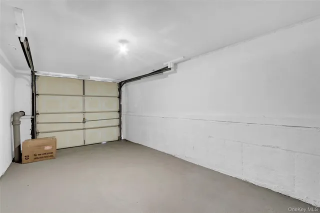 a view of room that has a wooden floor and white walls