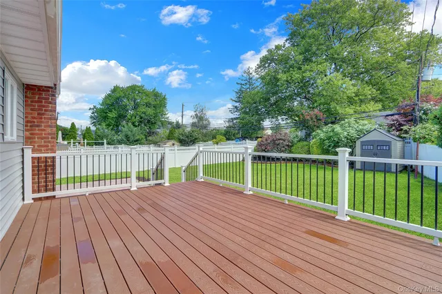 a view of a deck with a big yard