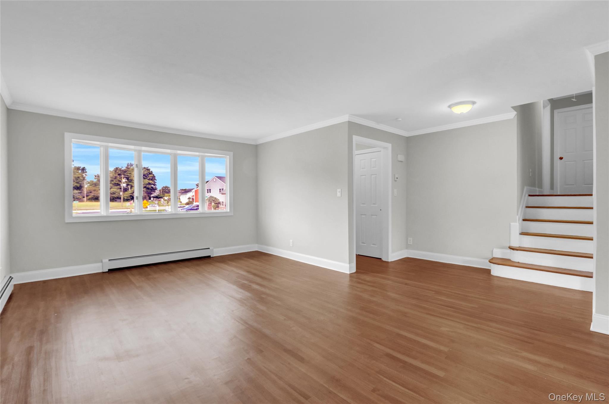 3621 Regent Lane Wantagh, NY 11793 - Photo 4 of 24 an empty room with wooden floor and window