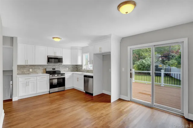 a kitchen with a refrigerator a stove top oven and sink