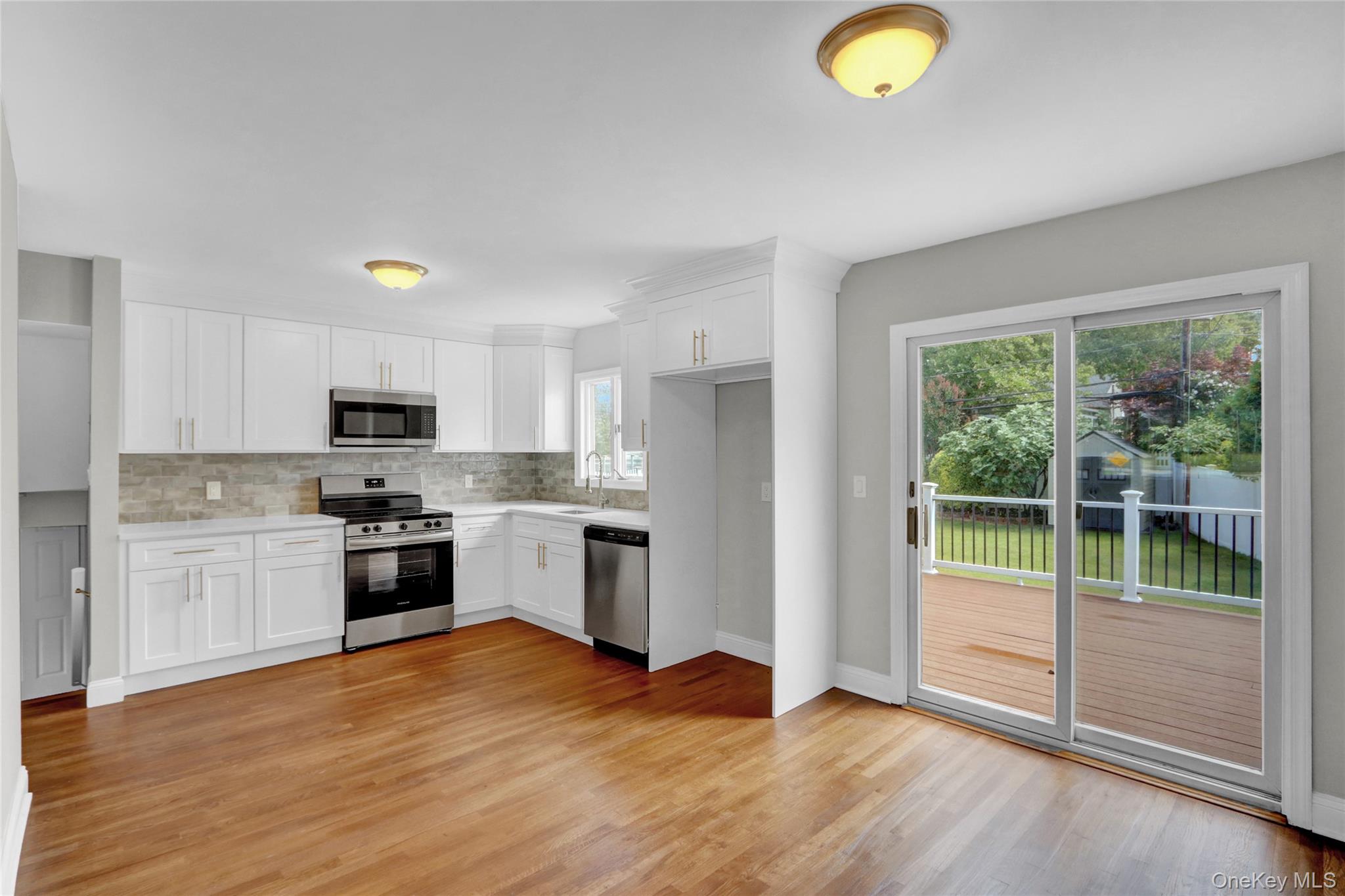 3621 Regent Lane Wantagh, NY 11793 - Photo 8 of 24 a kitchen with a refrigerator a stove top oven and sink