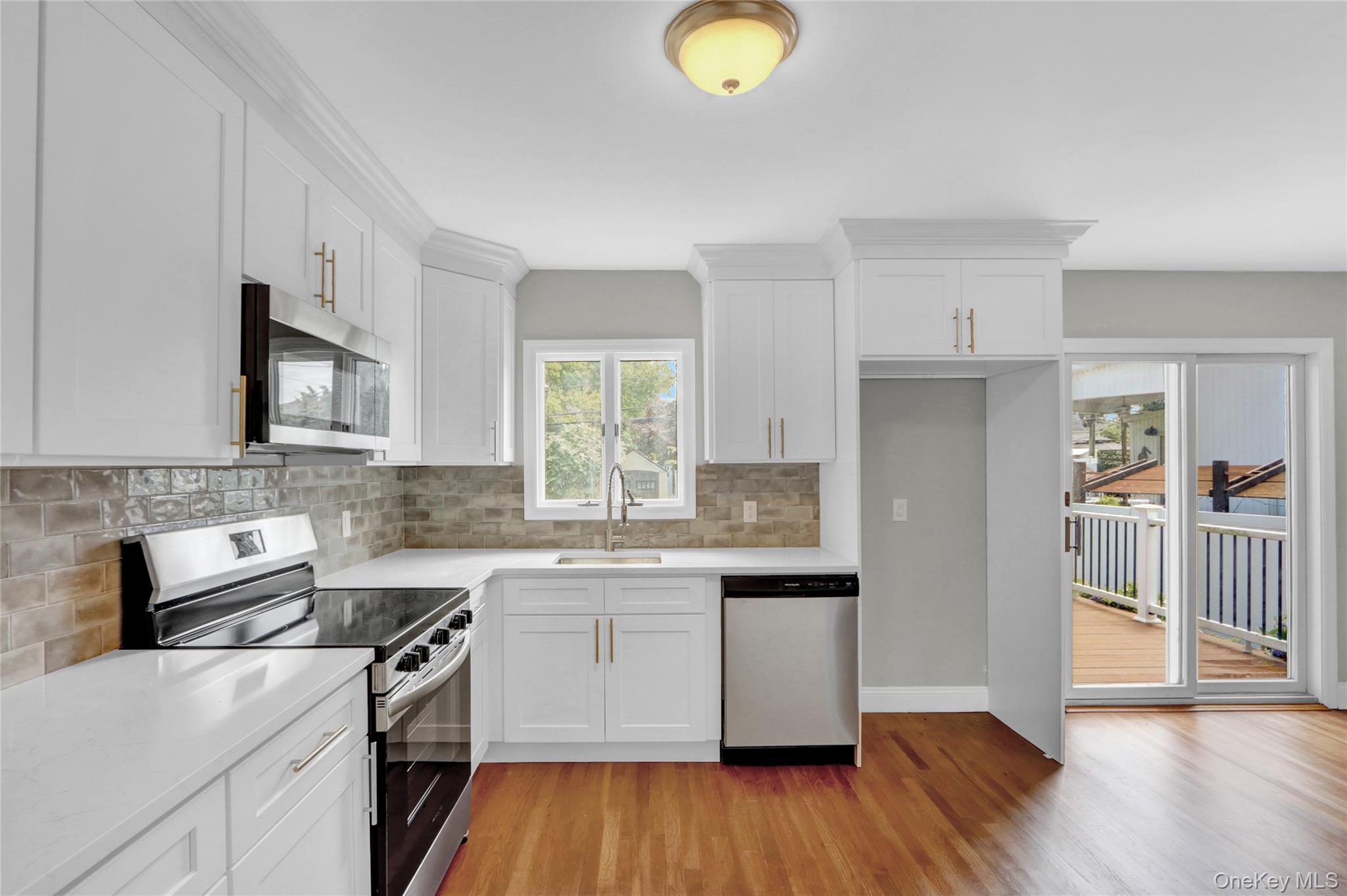 3621 Regent Lane Wantagh, NY 11793 - Photo 10 of 24 a kitchen with a sink a stove top oven and cabinetry
