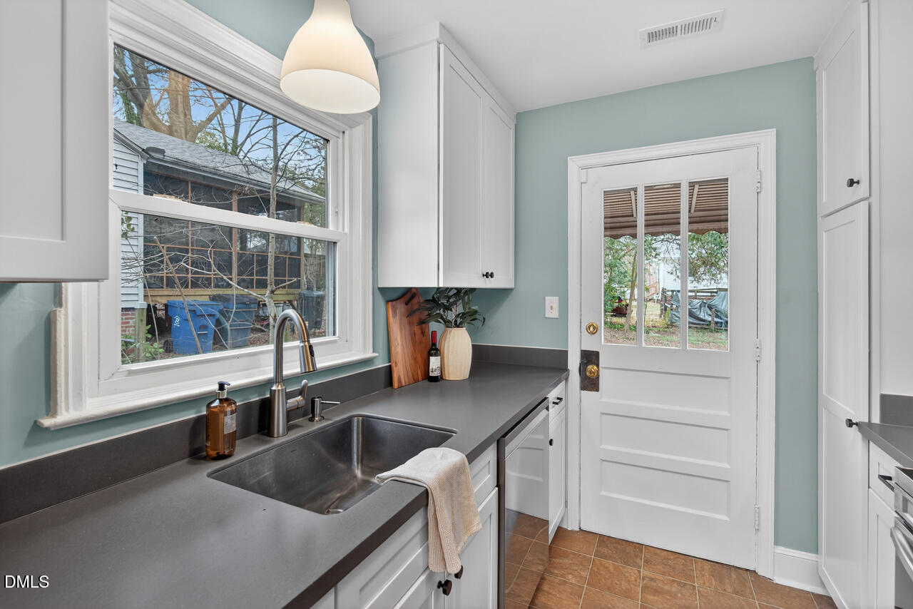 1811 Forest Road Durham, NC 27705 - Photo 10 of 26 a kitchen with stainless steel appliances granite countertop a sink and a granite counter tops with a large window
