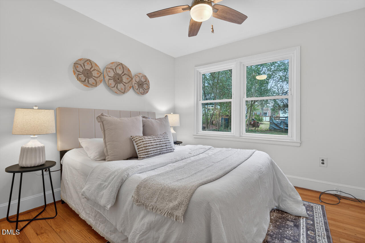 1811 Forest Road Durham, NC 27705 - Photo 12 of 26 a bedroom with a bed and a large window