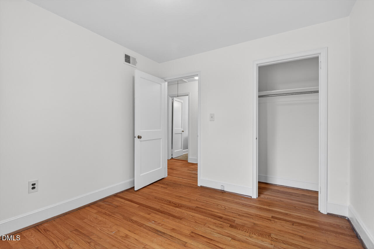 1811 Forest Road Durham, NC 27705 - Photo 19 of 26 a view of an empty room with wooden floor and closet