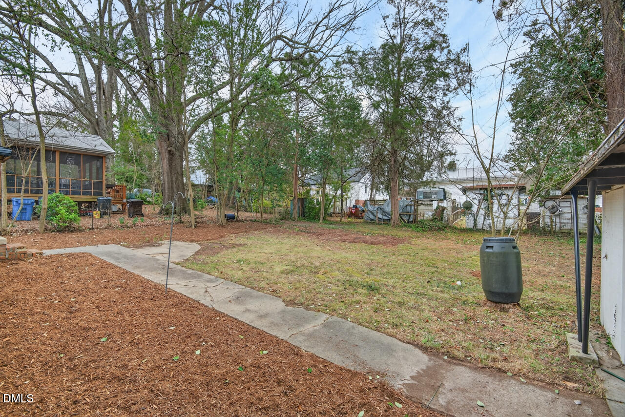 1811 Forest Road Durham, NC 27705 - Photo 20 of 26 a view of a backyard with large trees