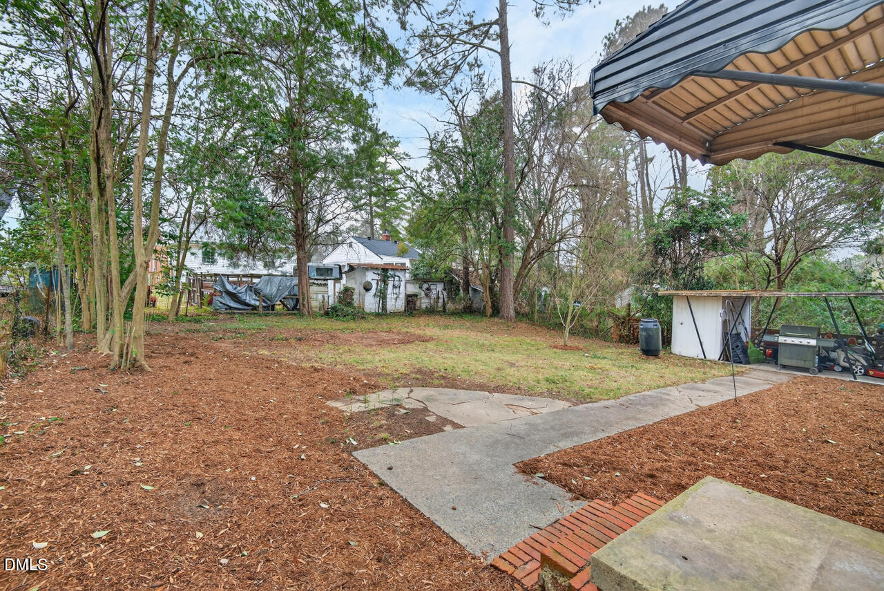 1811 Forest Road Durham, NC 27705 - Photo 21 of 26 a view of a backyard with a garden