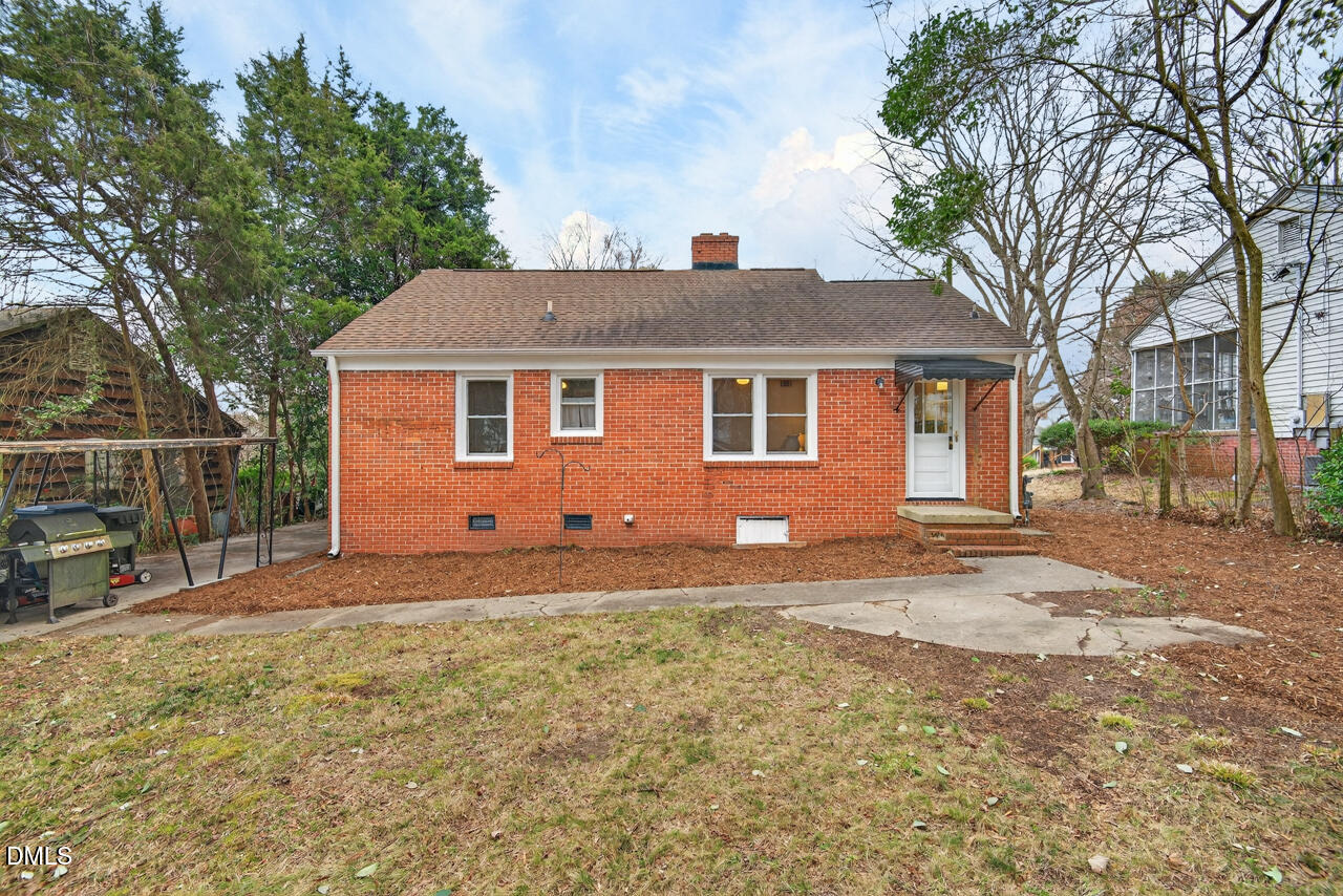 1811 Forest Road Durham, NC 27705 - Photo 24 of 26 a view of a yard with a house and a tree