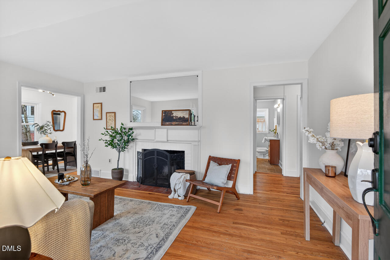 1811 Forest Road Durham, NC 27705 - Photo 2 of 26 a living room with furniture and a fireplace