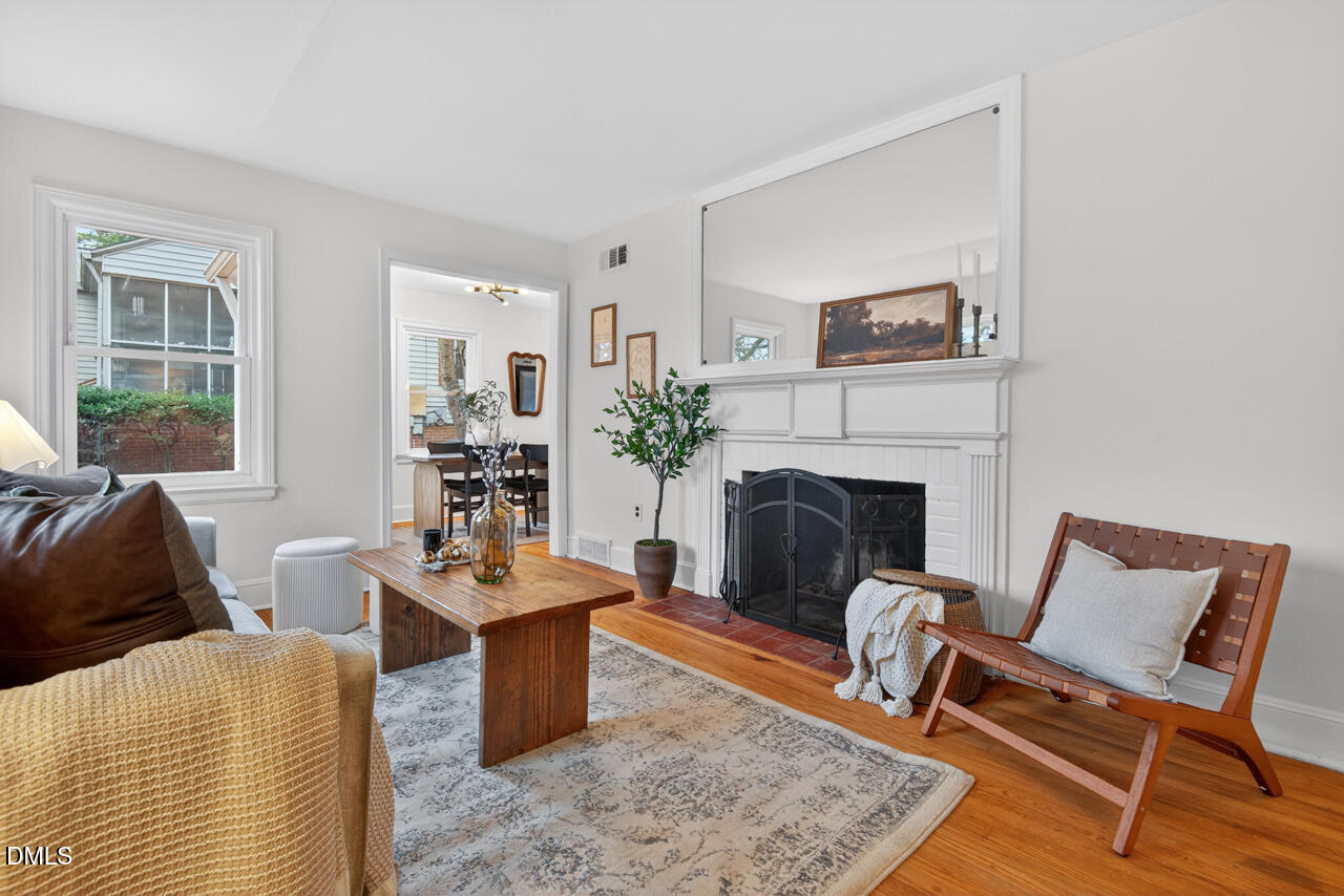 1811 Forest Road Durham, NC 27705 - Photo 3 of 26 a living room with furniture and a fireplace