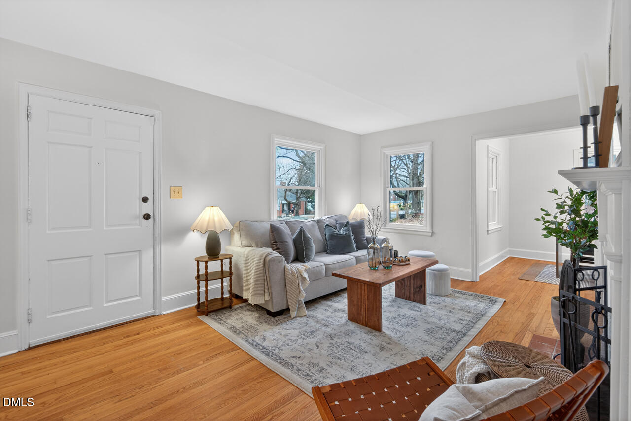 1811 Forest Road Durham, NC 27705 - Photo 4 of 26 a living room with furniture potted plant and wooden floor