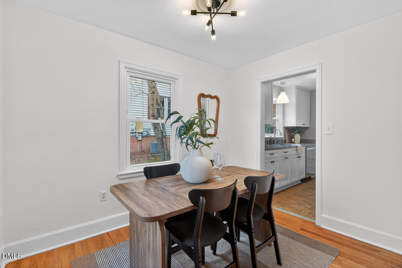1811 Forest Road Durham, NC 27705 - Photo 8 of 26 a view of a dining room with furniture and wooden floor