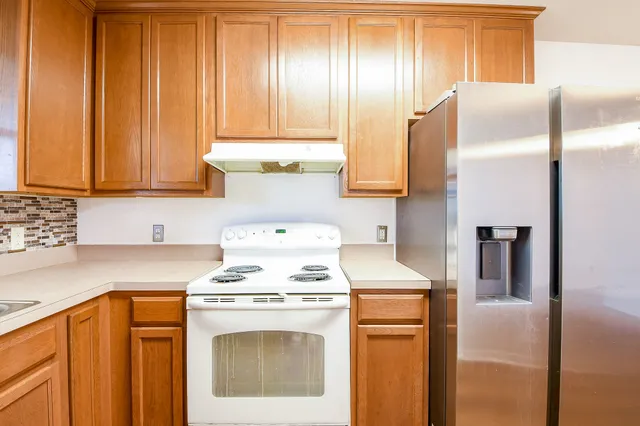 a kitchen with appliances cabinets and a counter top space