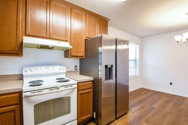 a kitchen with a refrigerator sink and stove