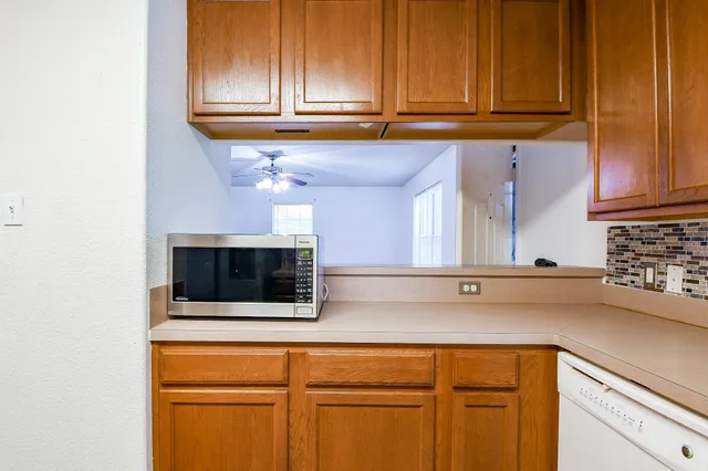 a kitchen with stainless steel appliances granite countertop a sink and a microwave