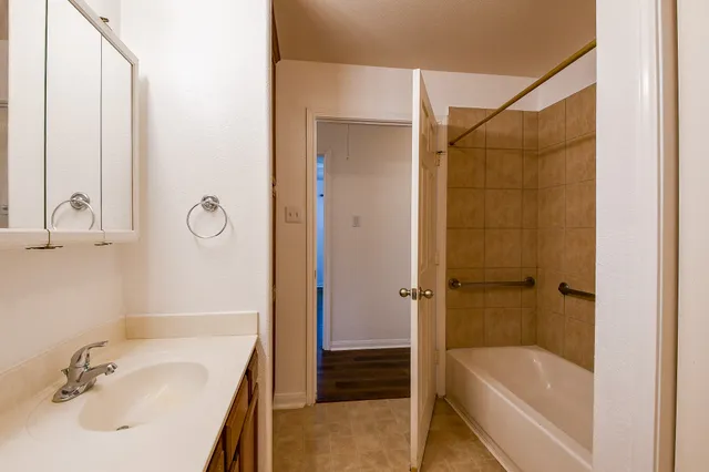 a bathroom with a tub and a sink