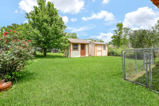 a view of house with backyard