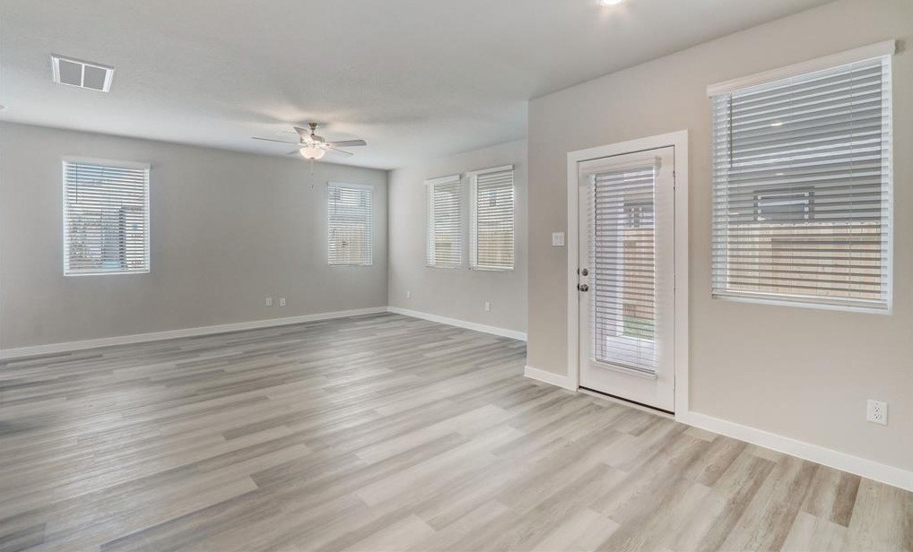 8403 Arden Valley Lane Houston, TX 77063 - Photo 15 of 32 an empty room with wooden floor and windows