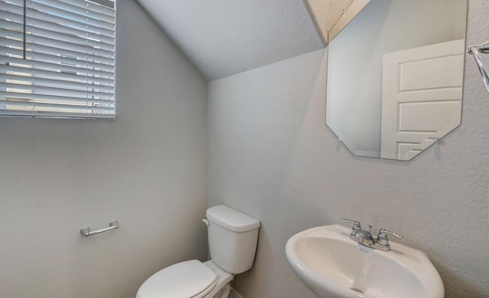 8403 Arden Valley Lane Houston, TX 77063 - Photo 16 of 32 a bathroom with a toilet sink and mirror