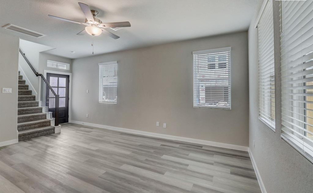 8403 Arden Valley Lane Houston, TX 77063 - Photo 6 of 32 a view of an empty room with a window and wooden floor