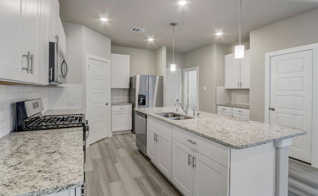 8403 Arden Valley Lane Houston, TX 77063 - Photo 8 of 32 a kitchen with a sink stove and refrigerator