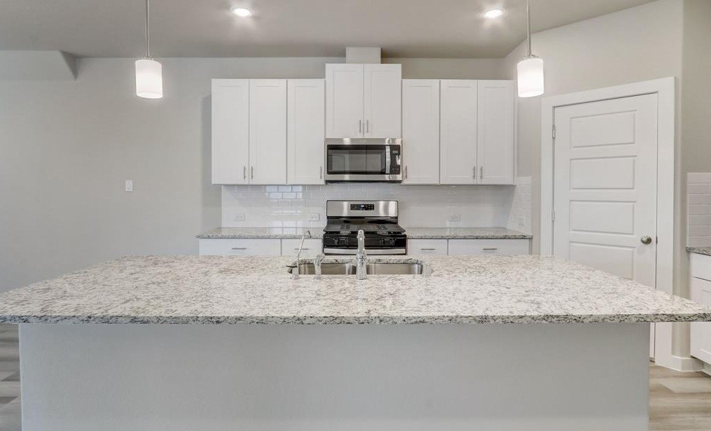 8403 Arden Valley Lane Houston, TX 77063 - Photo 10 of 32 a kitchen with granite countertop a sink a stove and cabinets