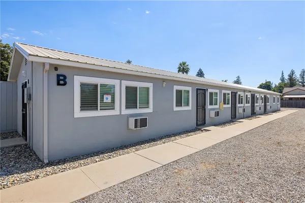 a view of a patio with table and chairs with wooden floor and fence