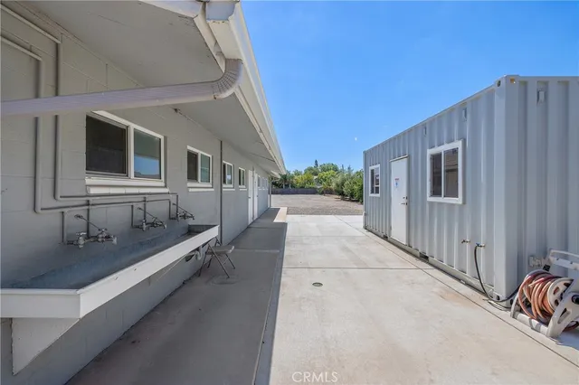 a kitchen with a sink refrigerator and cabinets