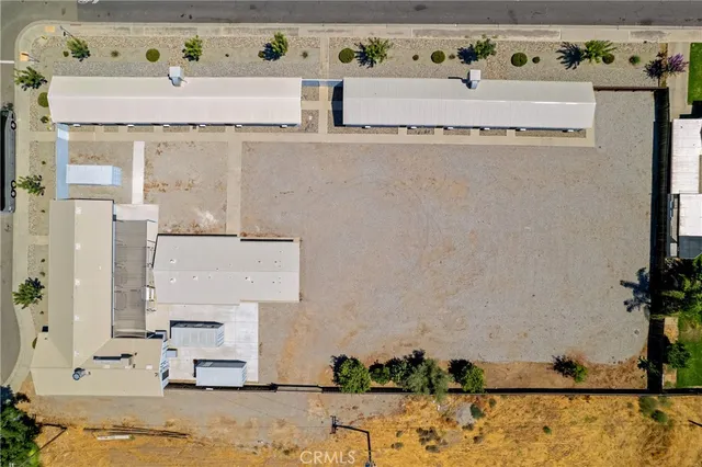 a potted plant sitting in front of a house with wooden fence