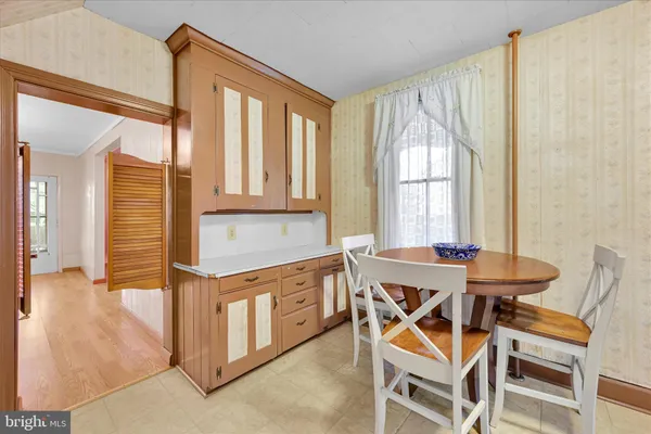 a view of a dining room with furniture and window
