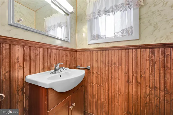 a bed sitting in a room next to a lamp