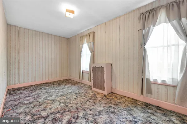 a view of a room with window and wooden floor