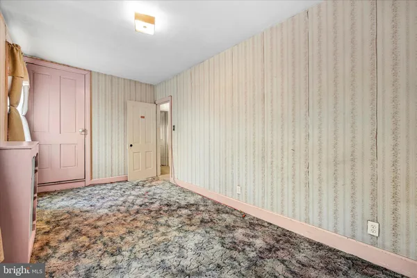 a bed room with a bed and a painting on the wall