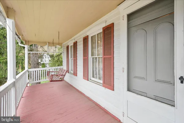 a view of an house with backyard and a tree