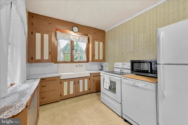 a kitchen with stainless steel appliances granite countertop a sink and a refrigerator