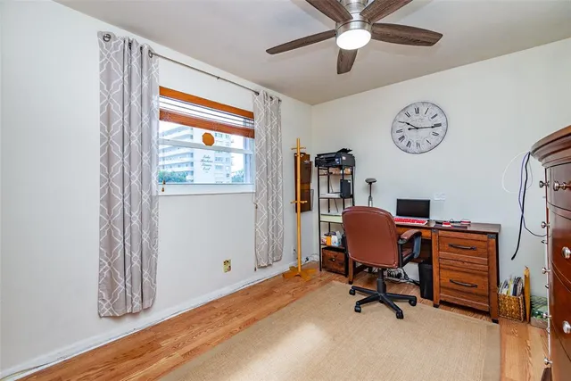a workspace with chandelier fan and a window