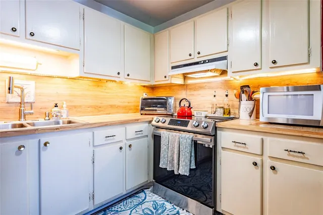 a kitchen with stainless steel appliances granite countertop a sink and cabinets