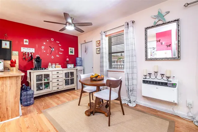 a work room with furniture a rug and a window
