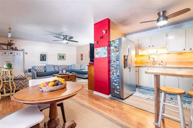 a living room with furniture and a kitchen view