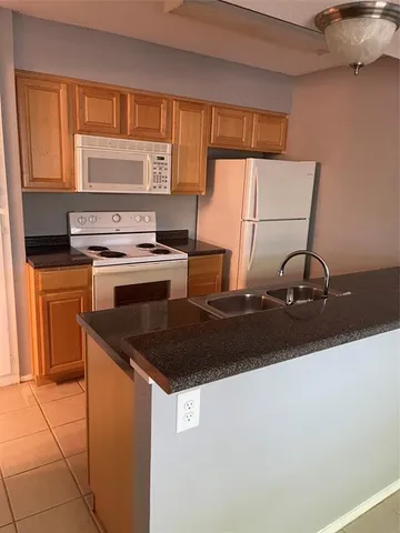 a kitchen with a sink a stove and cabinets