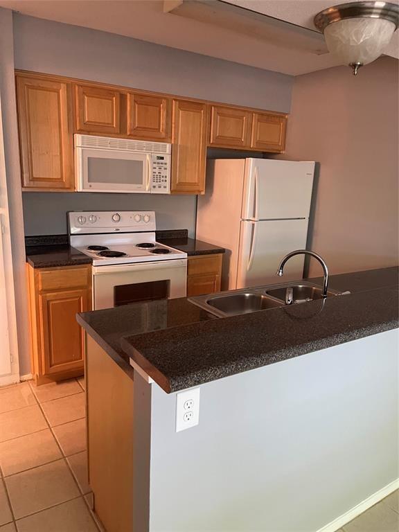 8114 Sonnet Avenue, Unit 102 Austin, TX 78759 - Photo 2 of 12 a kitchen with a sink a stove and cabinets
