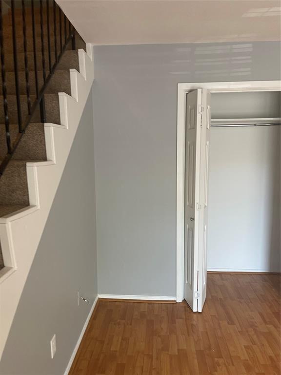 8114 Sonnet Avenue, Unit 102 Austin, TX 78759 - Photo 9 of 12 a view of an empty room with wooden floor and entryway