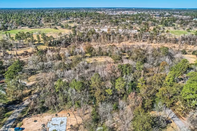 a view of a yard with wooden fence