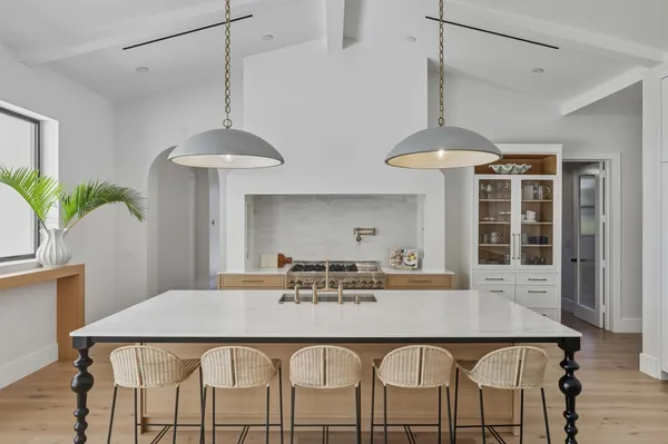 a kitchen with stainless steel appliances a stove and white cabinets
