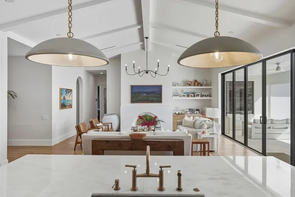 a living room with furniture chandelier and a couch